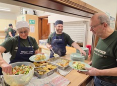 A host takes places from the kitchen hatch